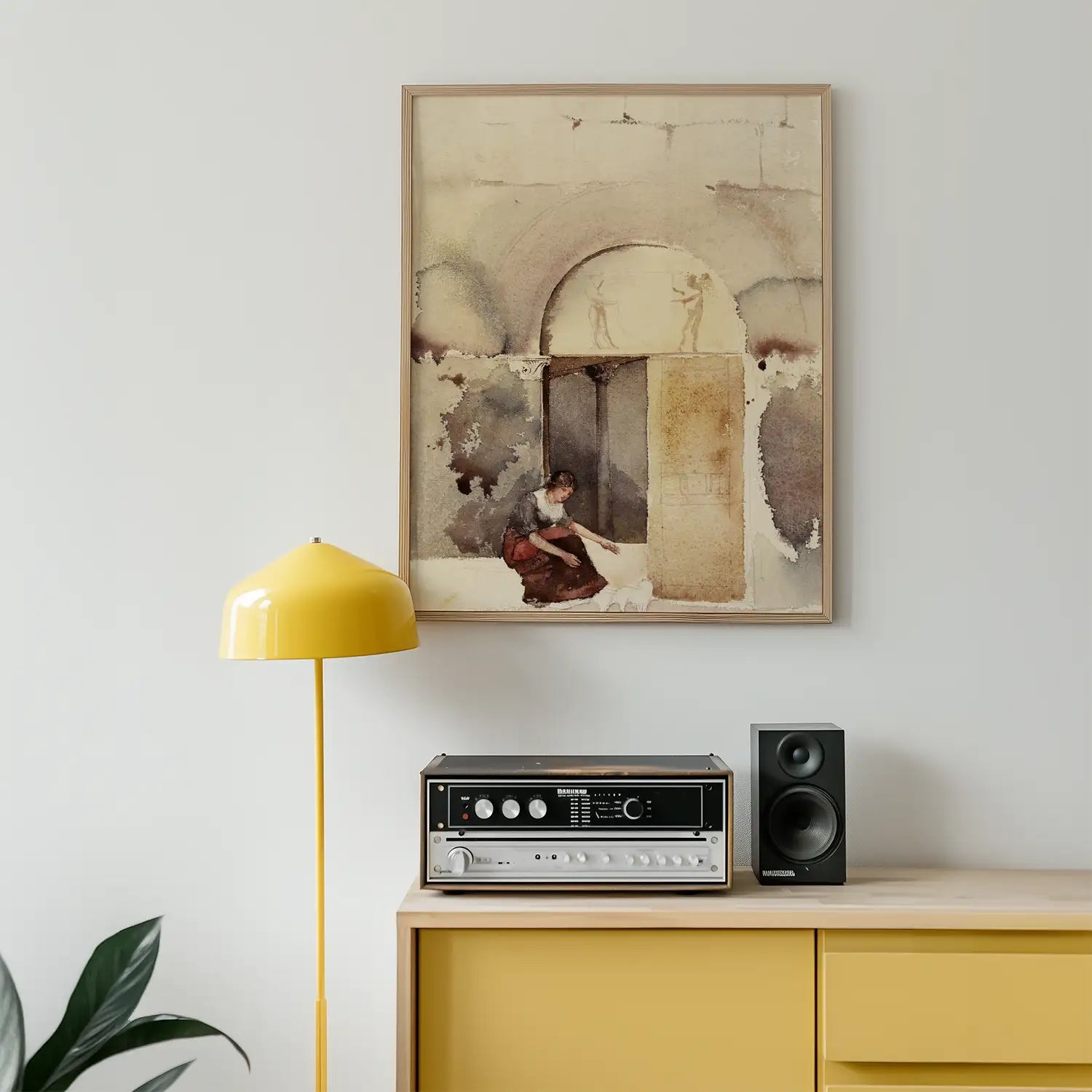 A watercolor painting of a woman cleaning in front of an arched doorway, displayed on a wall above a yellow lamp, vintage audio system, and a black speaker on a yellow cabinet.
