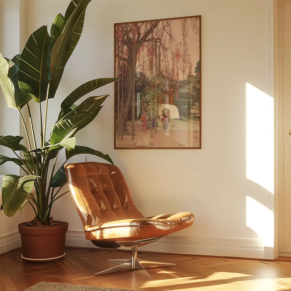 A cozy corner featuring a brown leather chair, a large potted plant, and a framed artwork depicting children playing near a serene landscape with a weeping tree.