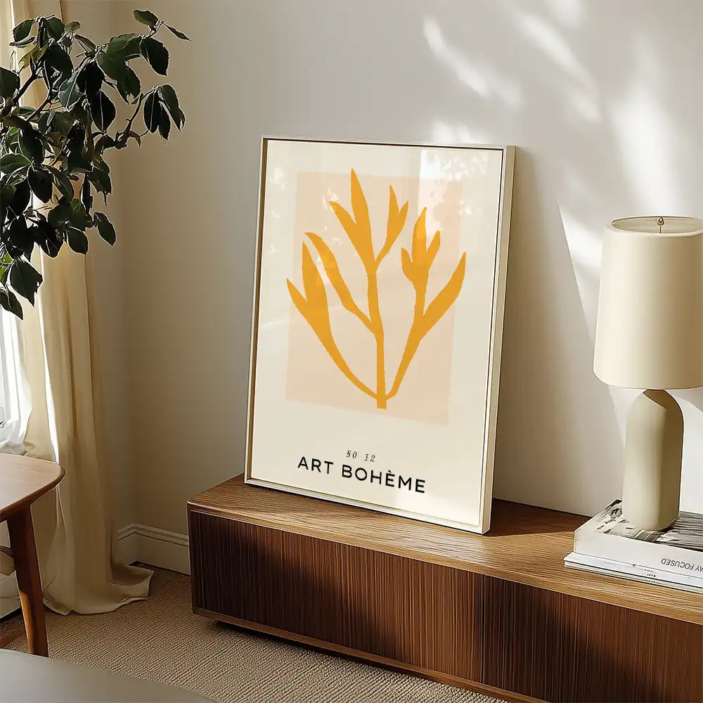 Modern poster featuring a minimalist botanical design in yellow, titled "Art Bohème," displayed in a stylish living room setting.