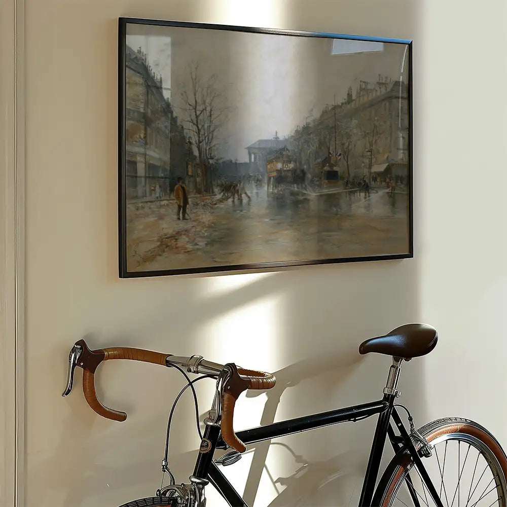 Framed painting of a city street scene hanging on a wall above a bicycle with wooden handlebars.