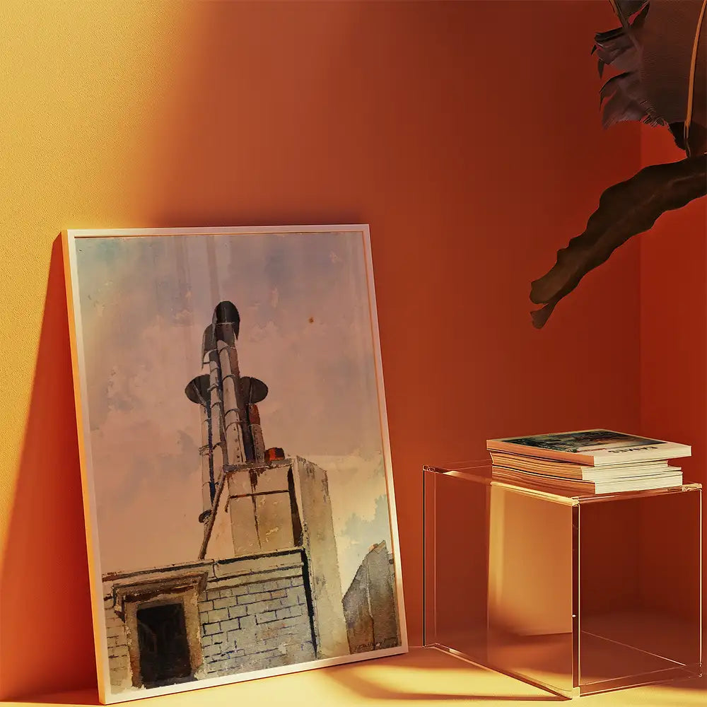 Painting of industrial chimneys displayed in a white frame against an orange wall, accompanied by a stack of books on a clear acrylic table.