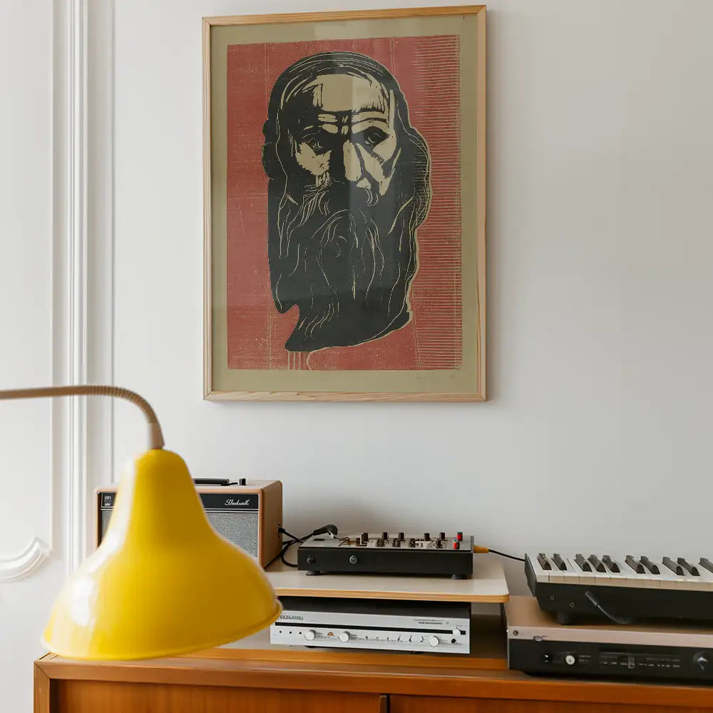 Artwork featuring a stylized portrait of a bearded man in a wooden frame, displayed on a wall above a wooden console with a yellow lamp and vintage audio equipment.