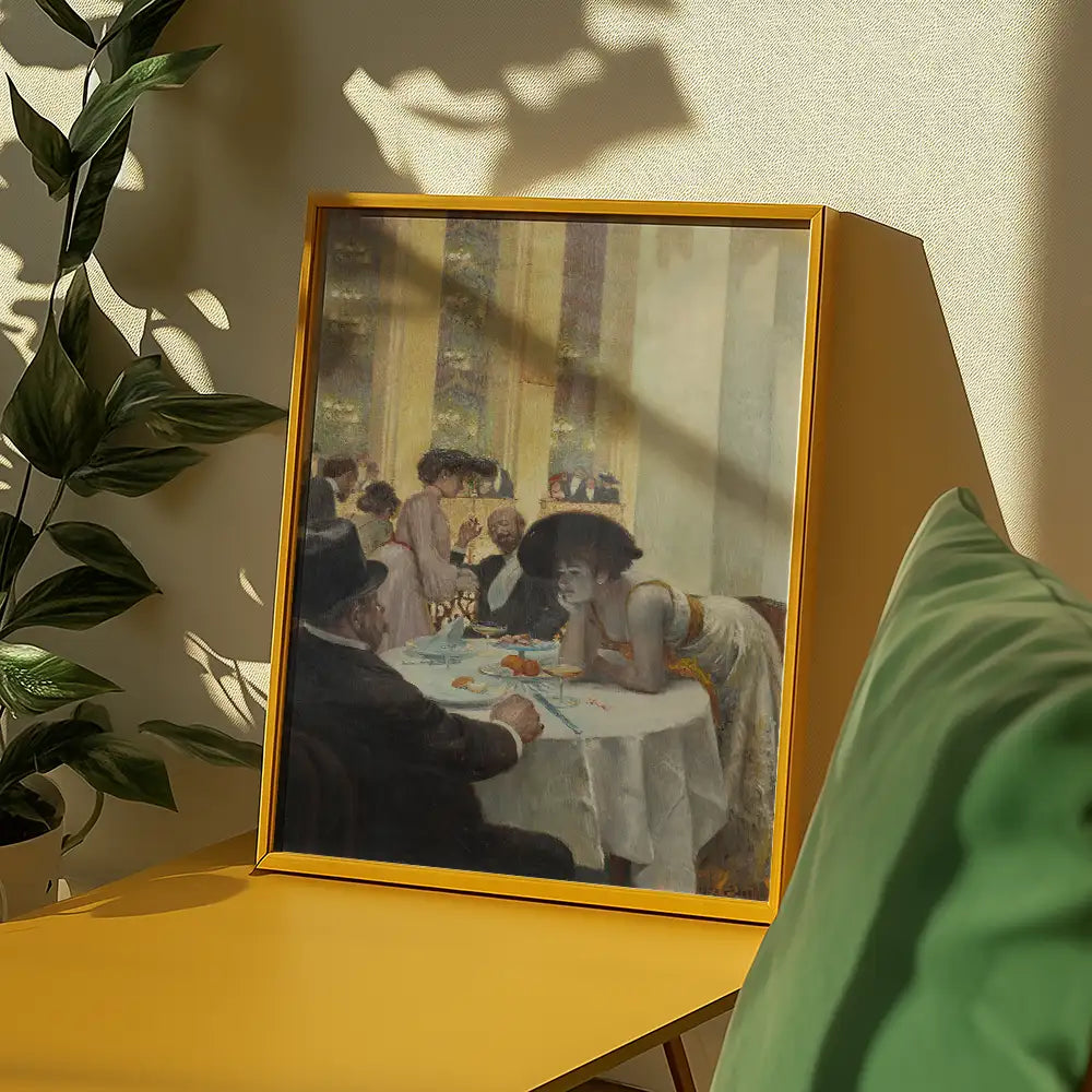 Framed painting of a social gathering at a dinner table with people dining, featuring a woman in a large hat leaning on the table, displayed on a yellow table against a soft backdrop.