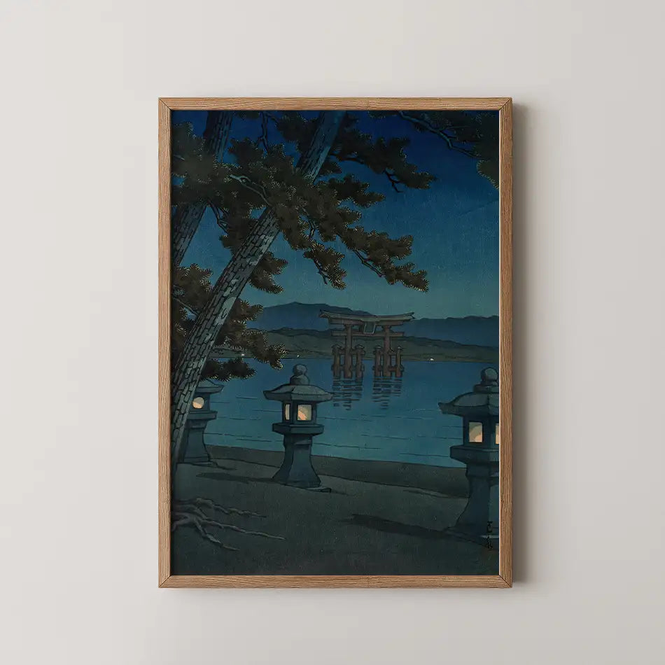 Framed painting of a serene nighttime landscape featuring lanterns, a torii gate by the water, and trees against a blue sky.