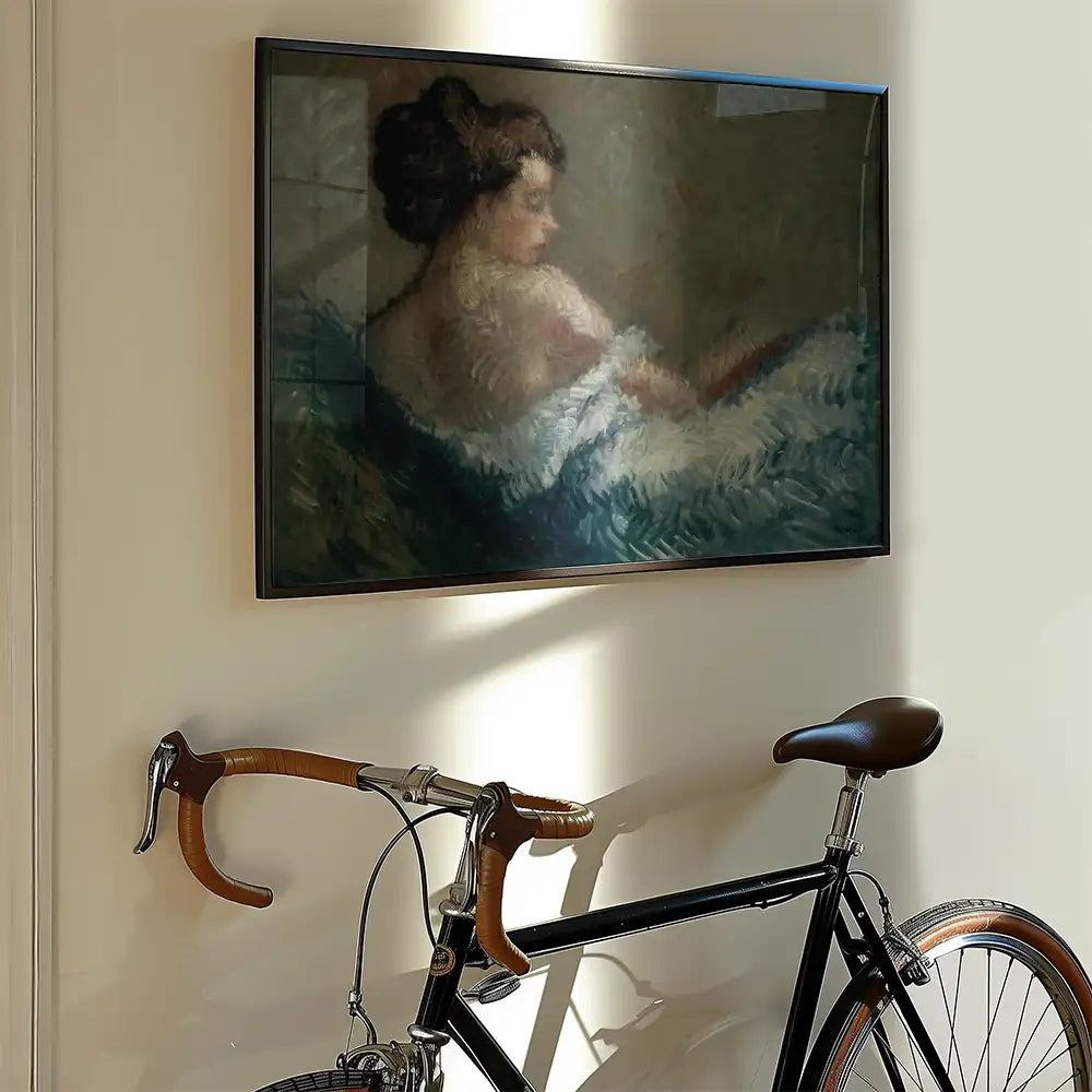 Painting of a woman lounging with a white blanket, framed and displayed on a wall next to a bicycle.