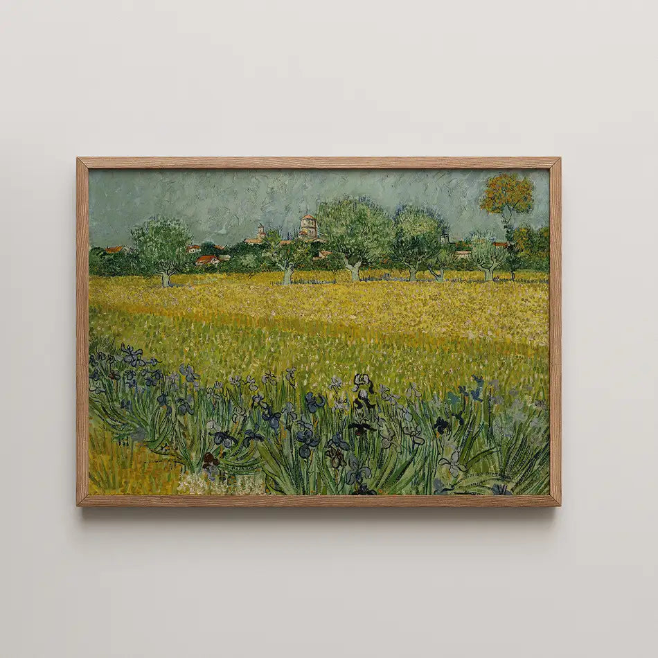Framed painting of a vibrant yellow field with green trees and a distant village under a blue sky.