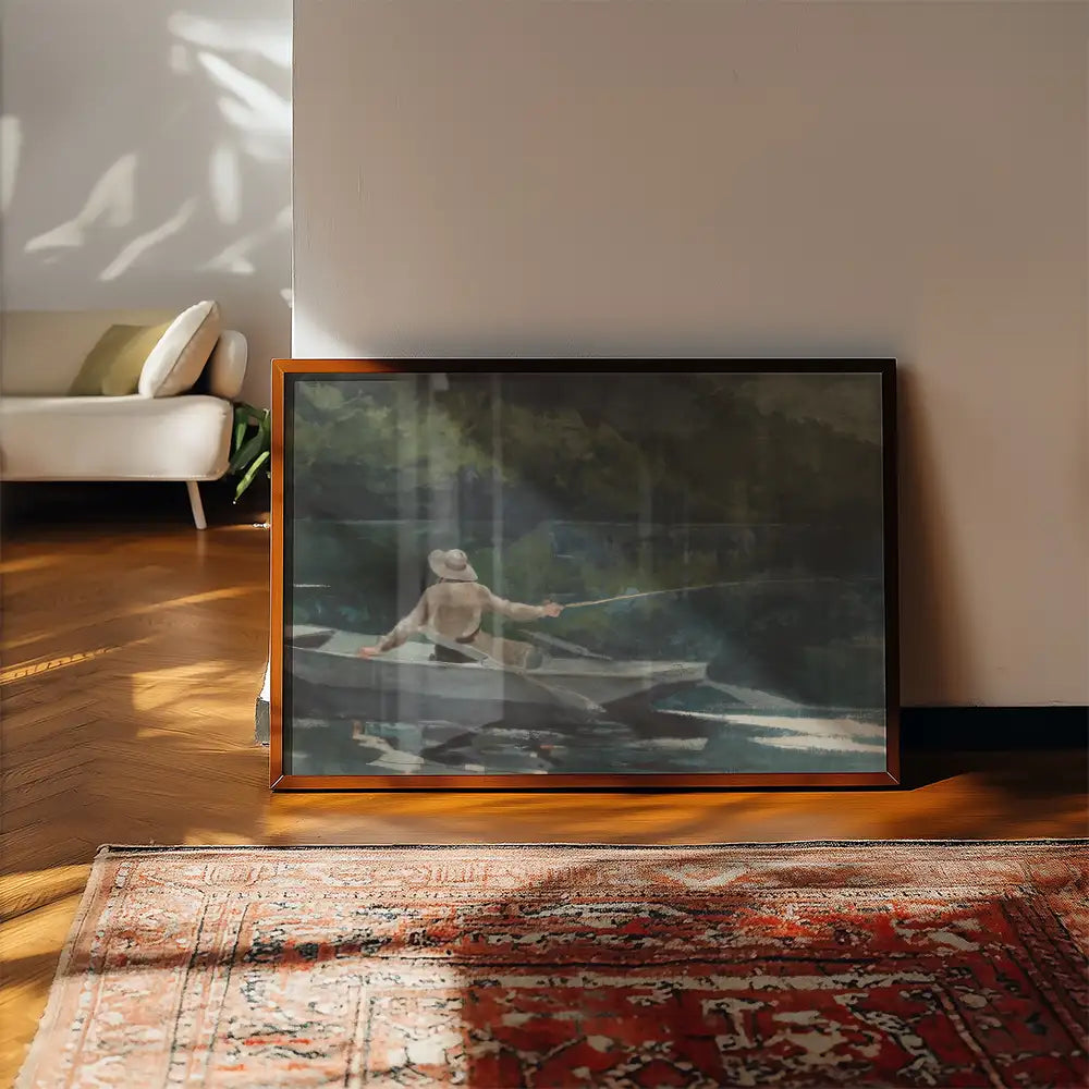 Framed painting of a fisherman in a boat surrounded by lush greenery, leaning back while casting a fishing rod, set in a cozy interior with a patterned rug.
