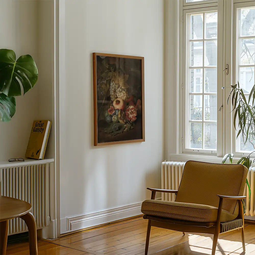 Framed still life painting featuring fruits and flowers on a wall in a cozy living room setting.