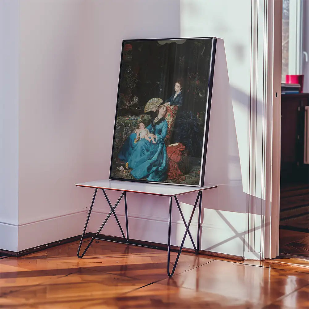 Framed painting featuring a woman in a blue dress seated with a child, displayed on a modern table in a bright room setting.