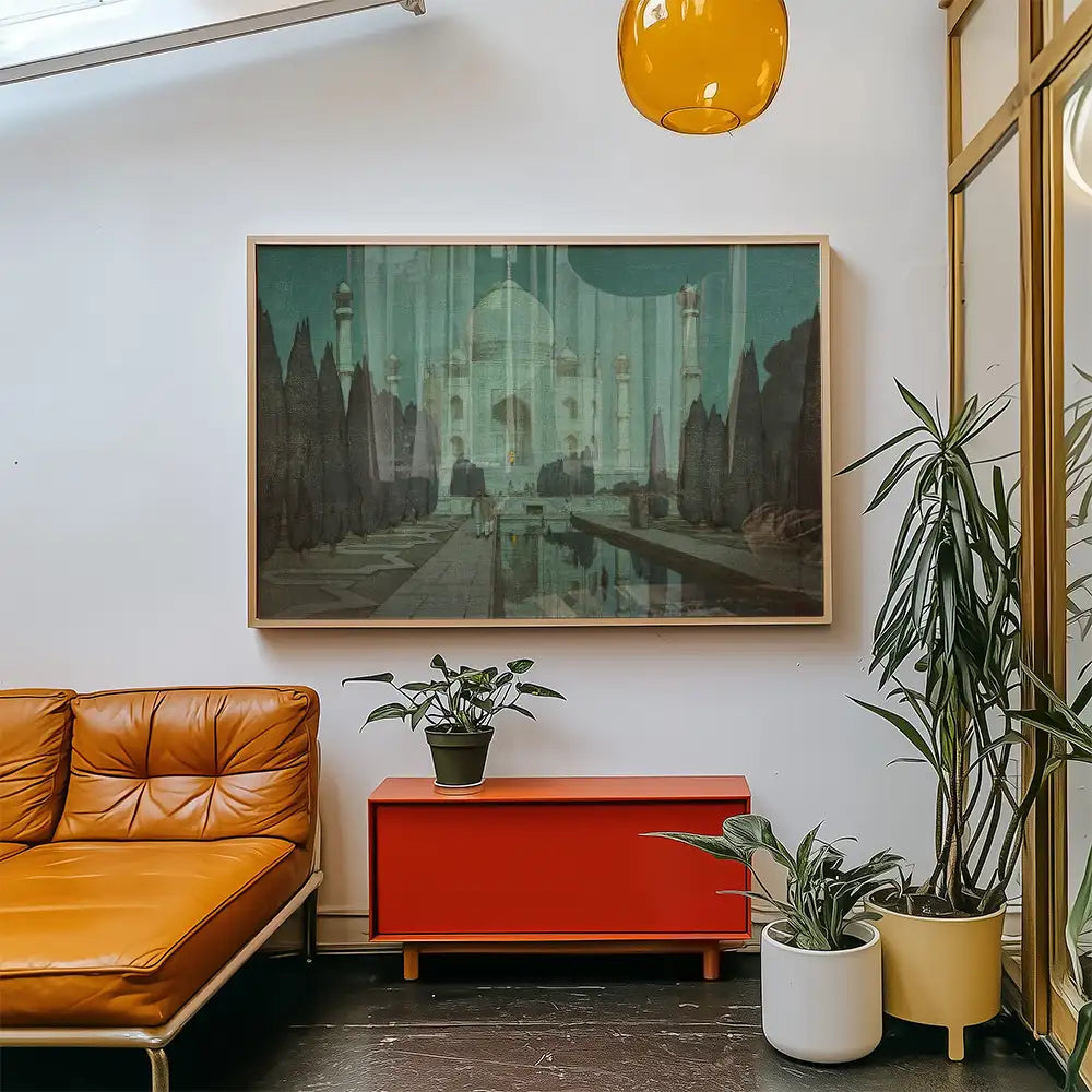 Painting of a historical monument displayed in a modern living room with a brown couch, red cabinet, and houseplants.