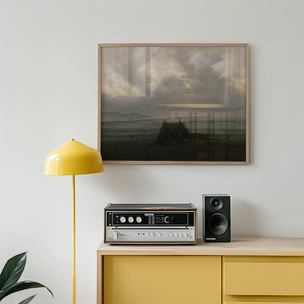 Framed painting of a landscape with clouds and birds, displayed above a yellow lamp and a vintage audio system on a light wooden cabinet.
