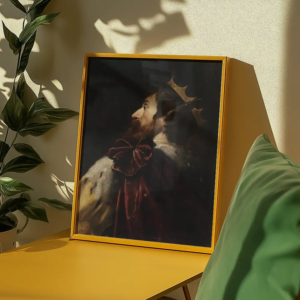 Framed painting of a king with a crown and red robe displayed on a yellow table in a bright room with green cushions and plants.