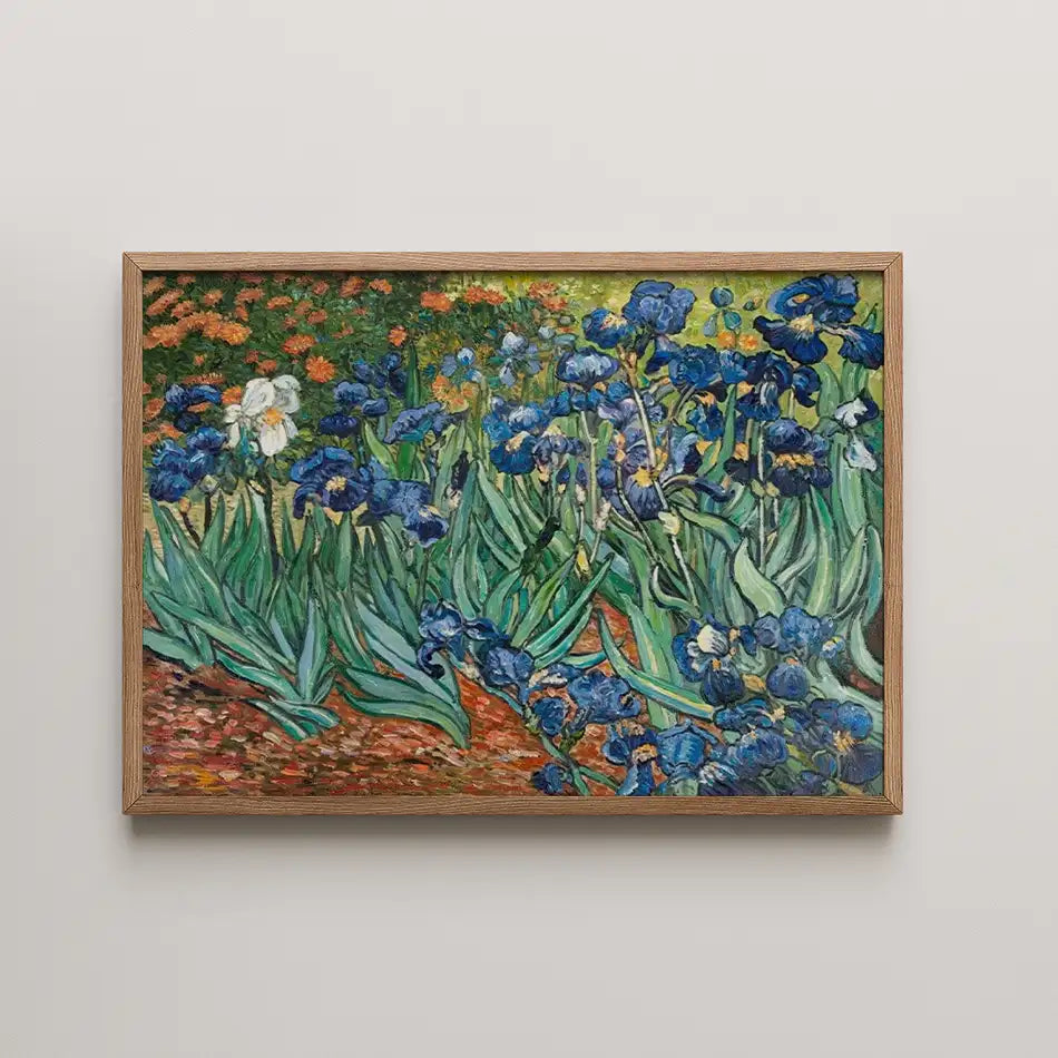 Framed painting of vibrant blue irises with green leaves and hints of orange flowers in the background.