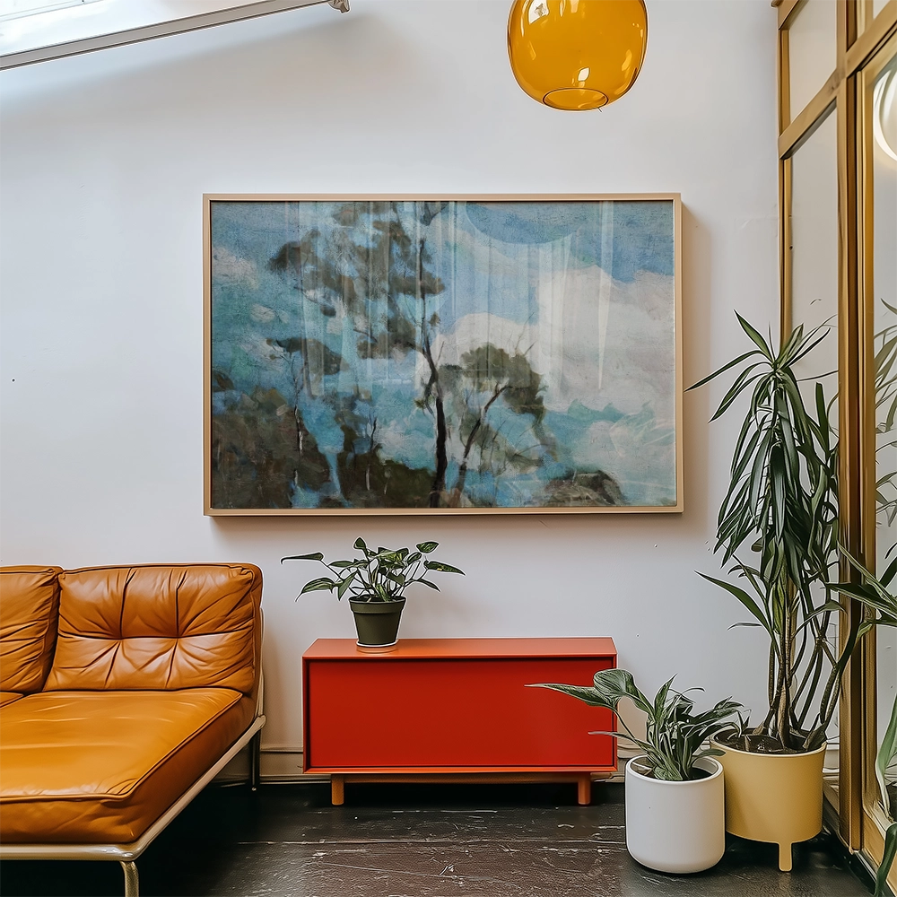 A framed painting featuring abstract trees and blue skies, displayed in a modern living space with an orange sofa, red cabinet, and various indoor plants.