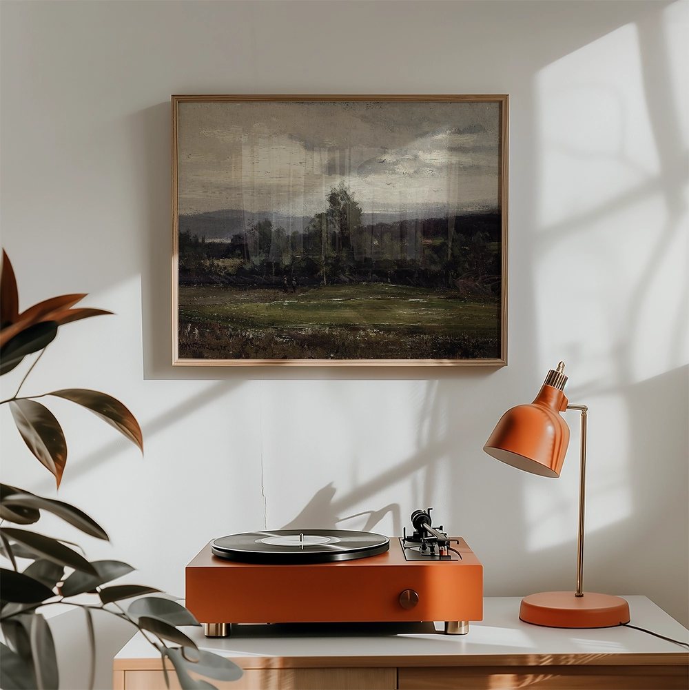 Painting of a serene landscape with trees and mountains, framed on a wall above a vintage orange record player and lamp in a sunlit room.