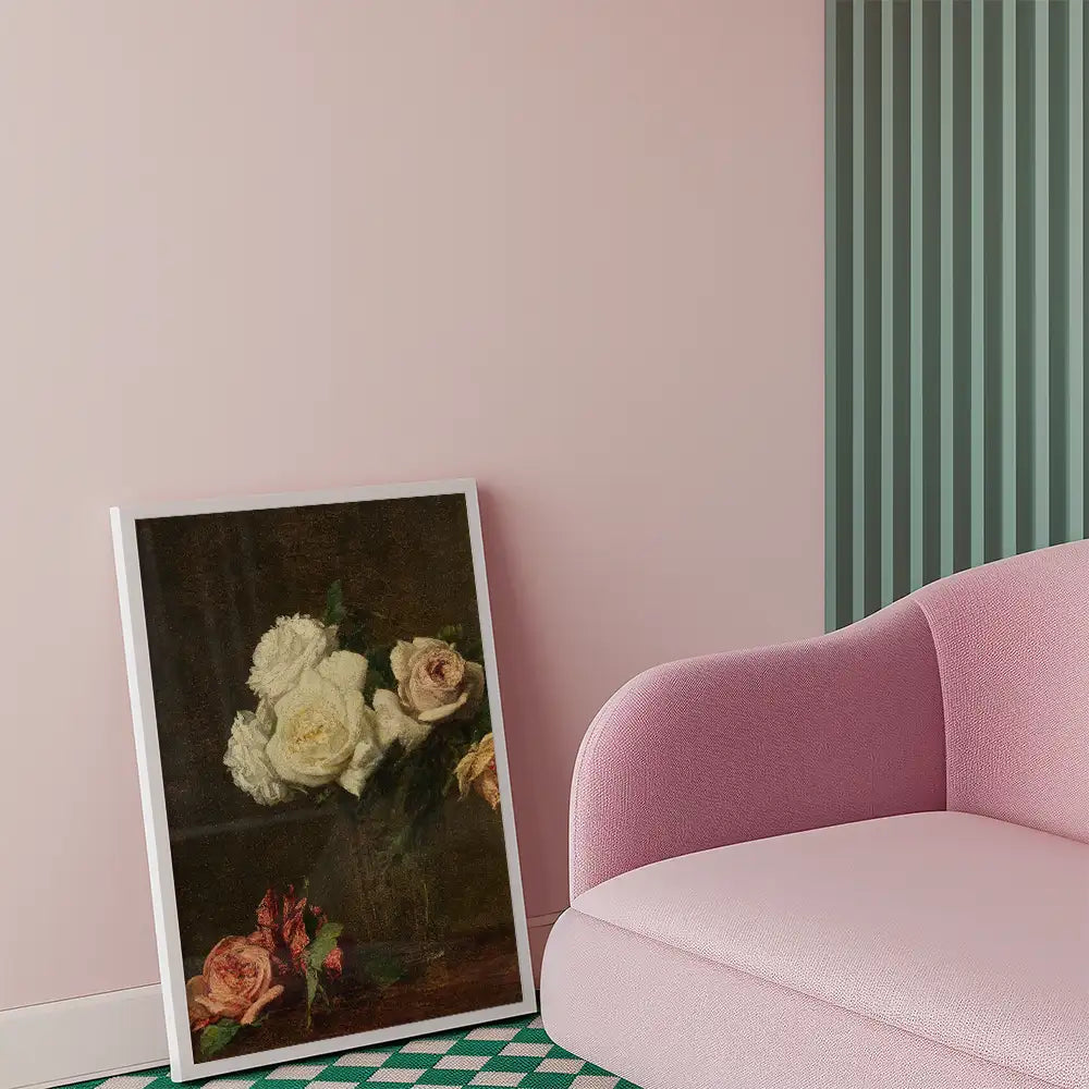 A framed painting of white and pink roses leaning against a pink wall near a modern pink sofa.