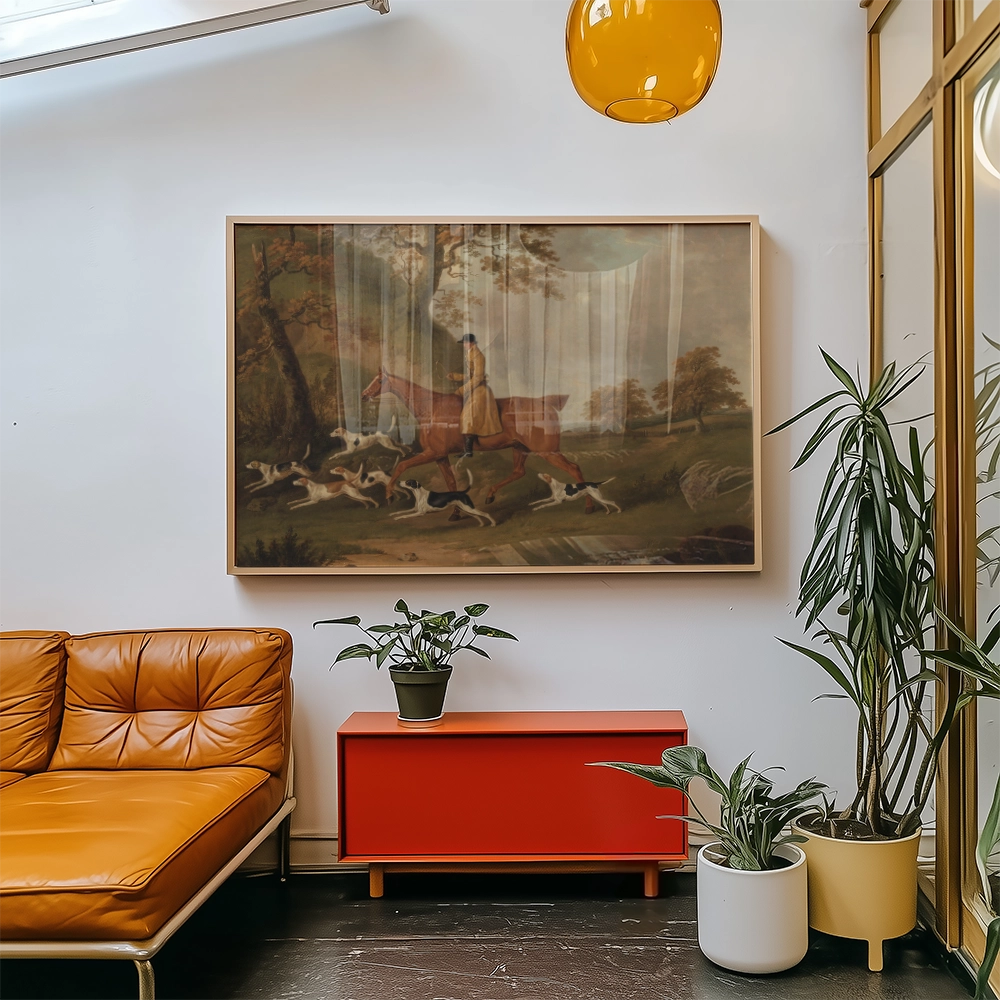 Framed painting of a horse and hounds in a natural landscape, displayed above a contemporary orange couch and a red modern cabinet, with indoor plants surrounding the furniture.