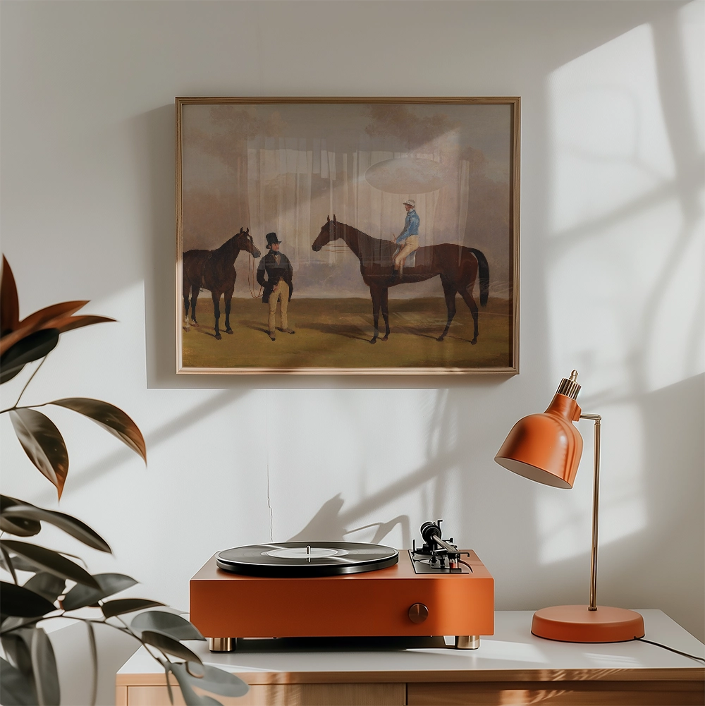 Painting of two horses and riders in a landscape, displayed above a vintage record player and an orange desk lamp.
