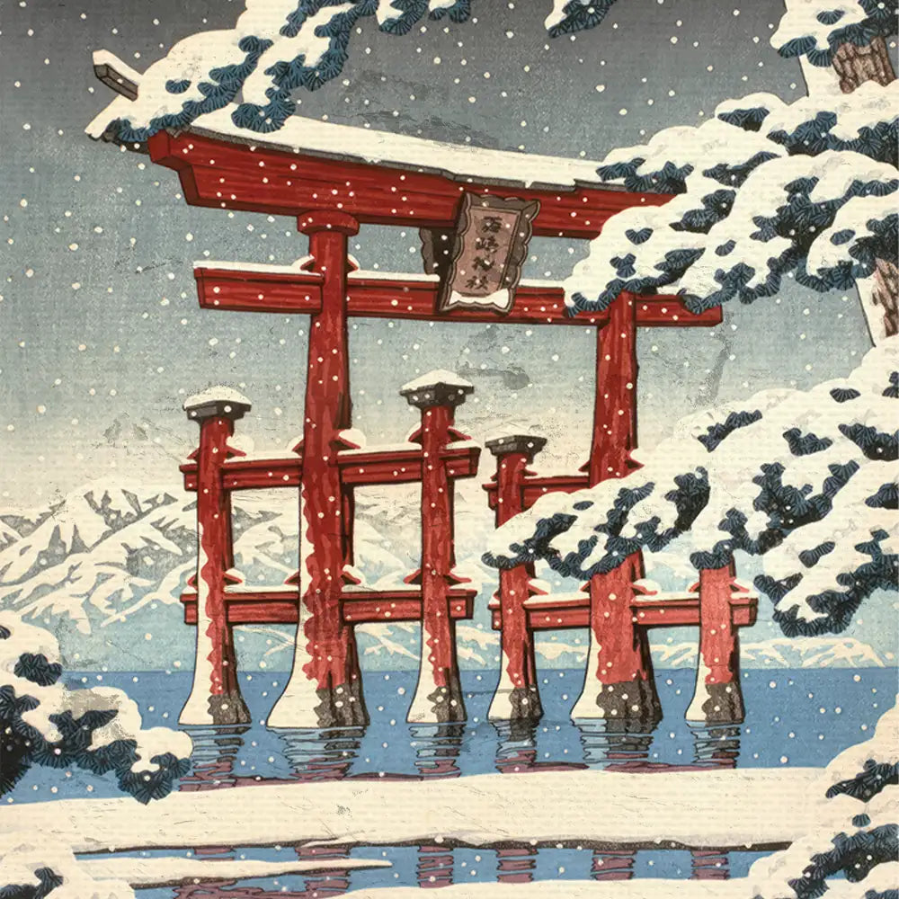 Snow-covered torii gate in a serene winter landscape with mountains in the background.