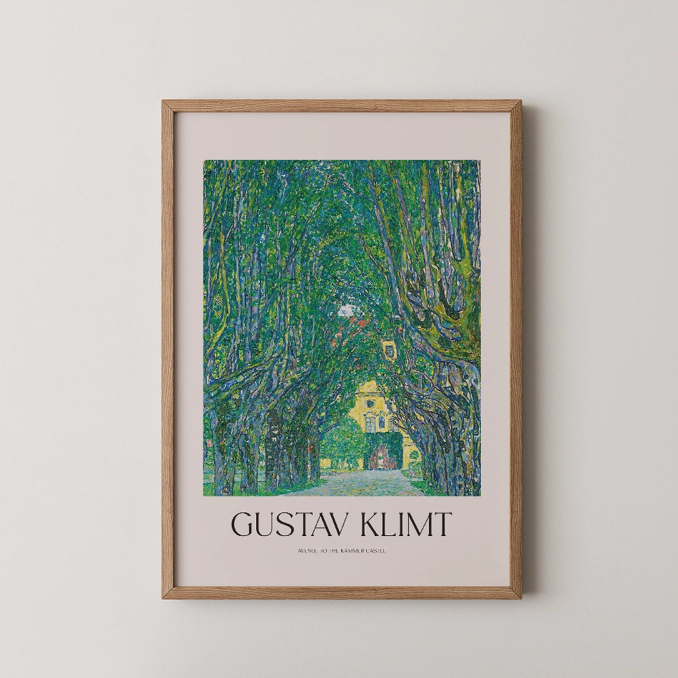 Gustav Klimt painting poster featuring a vibrant green tree-lined path with a yellow building in the background, framed in natural wood.
