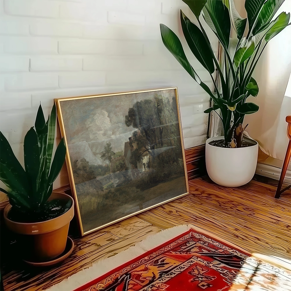 A framed painting leaning against a wall next to a potted plant, with a wooden floor and a colorful rug in the foreground.