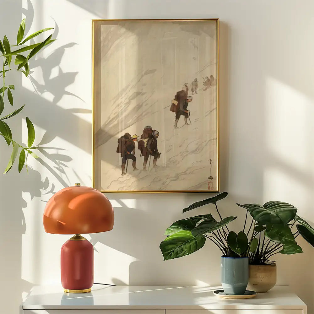 Painting of hikers ascending a mountain, framed in gold, displayed on a wall next to a vintage lamp and potted plants.