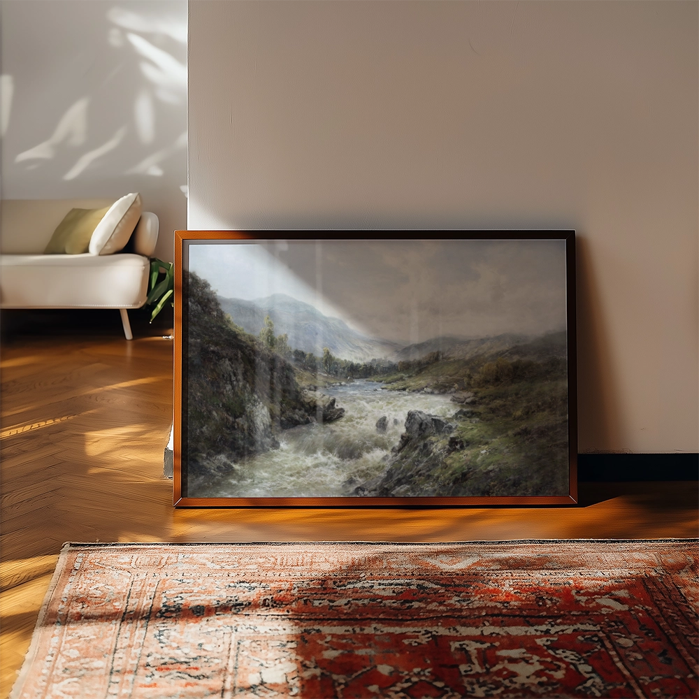 Framed landscape painting of a river flowing through a hilly terrain, with soft lighting and a cozy interior setting.