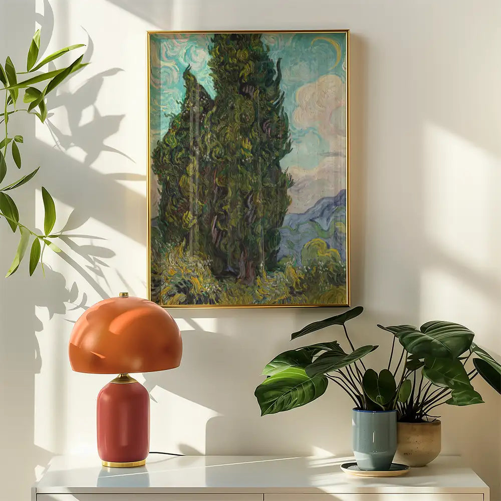 Painting of cypress trees against a colorful sky, framed and displayed on a wall, accompanied by a decorative lamp and potted plants.