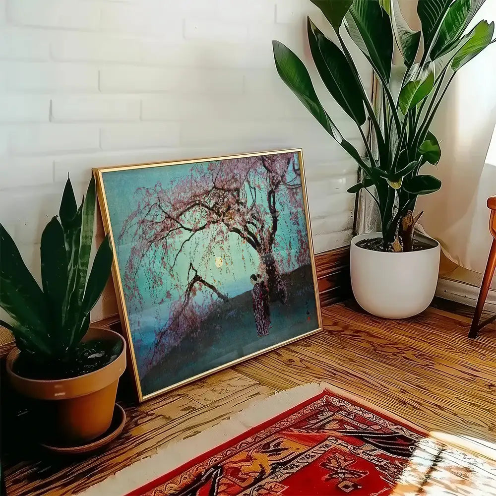 Framed painting of a cherry blossom tree in soft colors, displayed in a cozy interior setting with potted plants and a decorative rug.