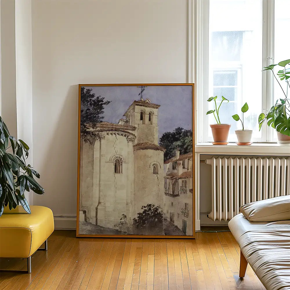 Framed painting of a historic building with a cross, displayed in a bright living room setting with plants and furniture.