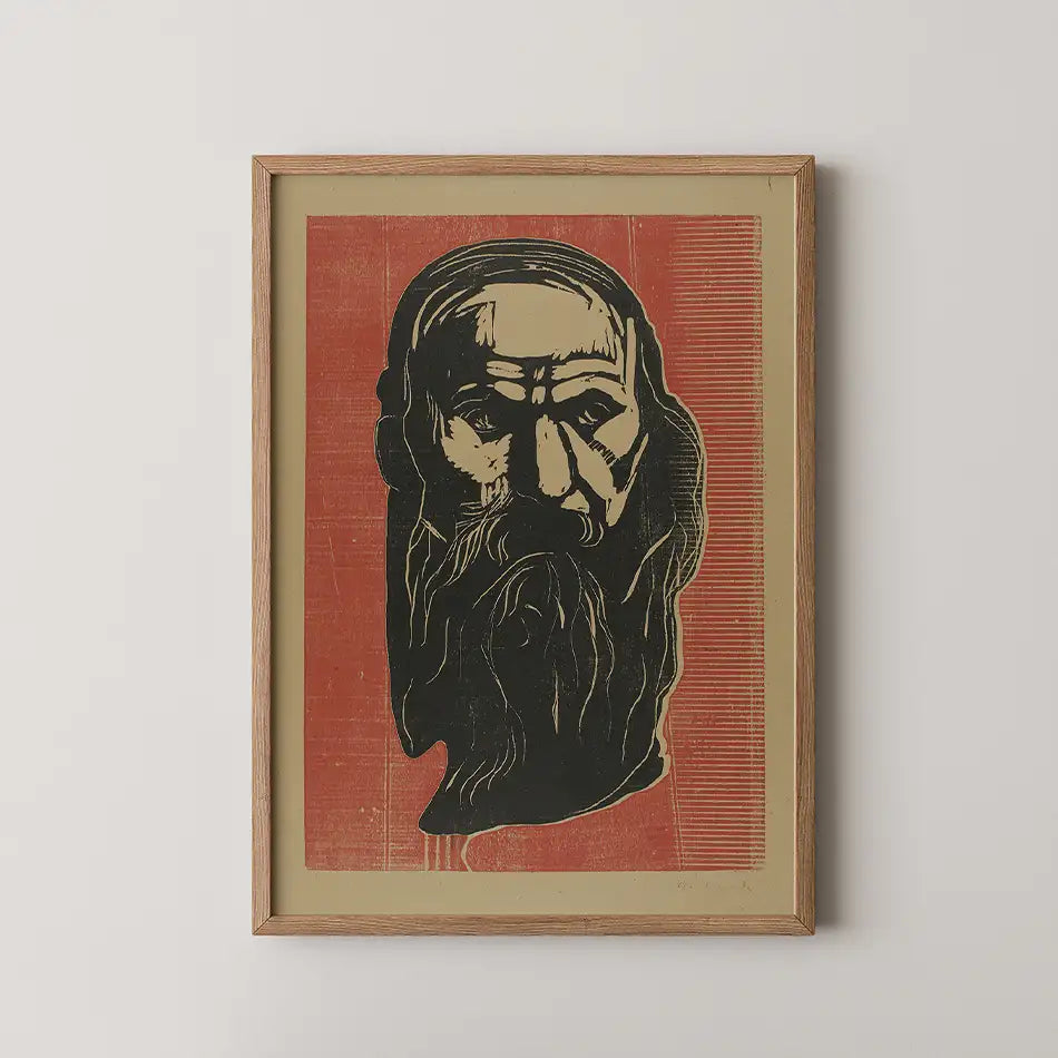 Black and white artistic portrait of an elderly man with a long beard, set against a bold red background, framed in wood.