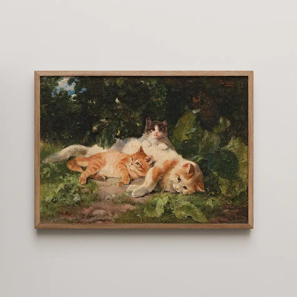 Painting of three cats resting among green foliage, framed in wood.