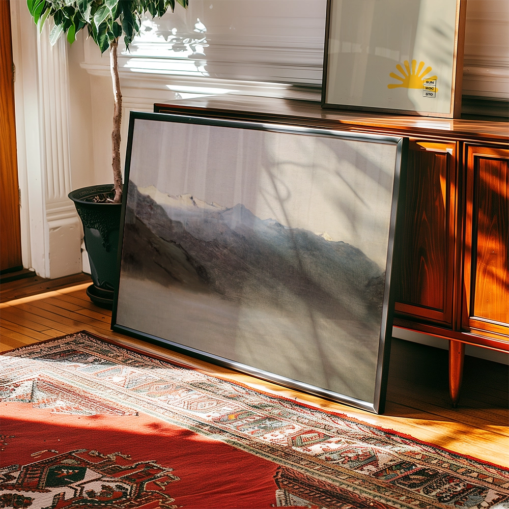Framed landscape painting leaning against a wooden cabinet, with a potted plant in the background and a patterned rug on the floor.