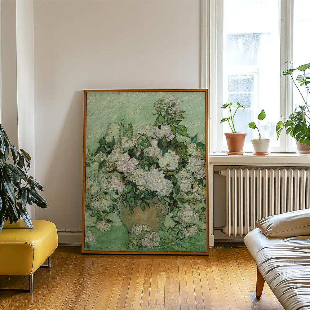 Framed painting of white flowers in a vase on a green background, displayed in a cozy living room with plants and a yellow chair.