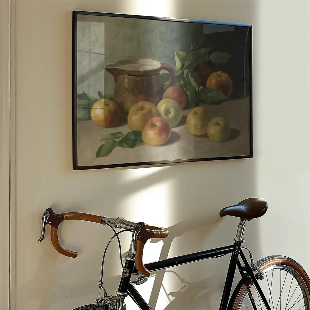 Still life painting of apples and a pitcher displayed on a wall next to a bicycle.