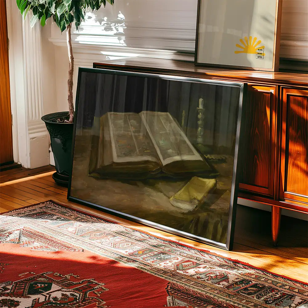 A framed painting of an open book with colorful illustrations, resting on a textured surface, surrounded by natural light and indoor greenery.
