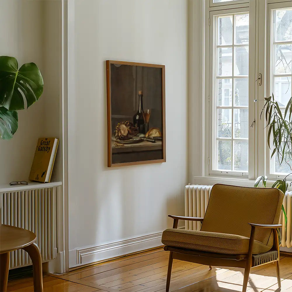 A cozy interior space featuring a framed painting of still life with wine and fruit, a comfortable chair, and a potted plant by a sunlit window.