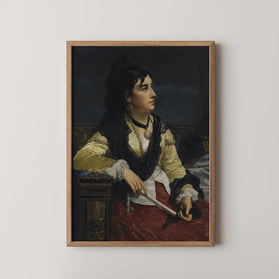 Portrait of a woman in a yellow blouse and black shawl, holding a pair of scissors, framed and displayed on a white wall.