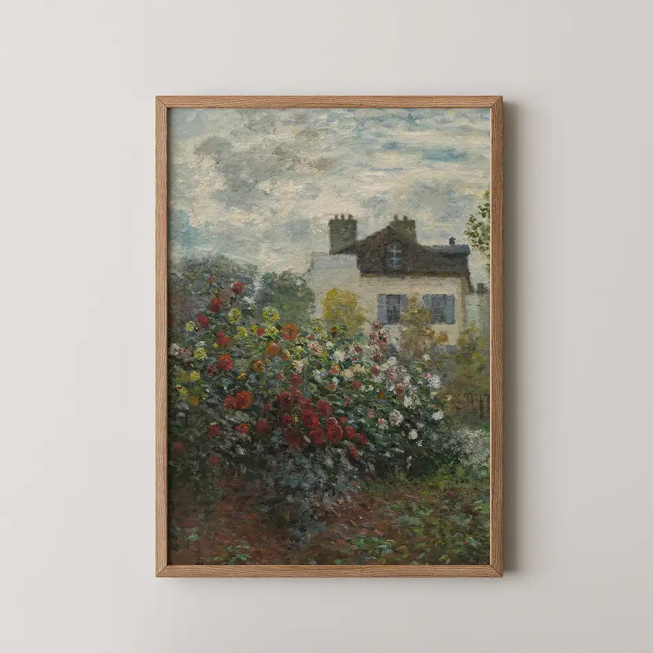 Framed painting of a house surrounded by colorful flowers under a cloudy sky.
