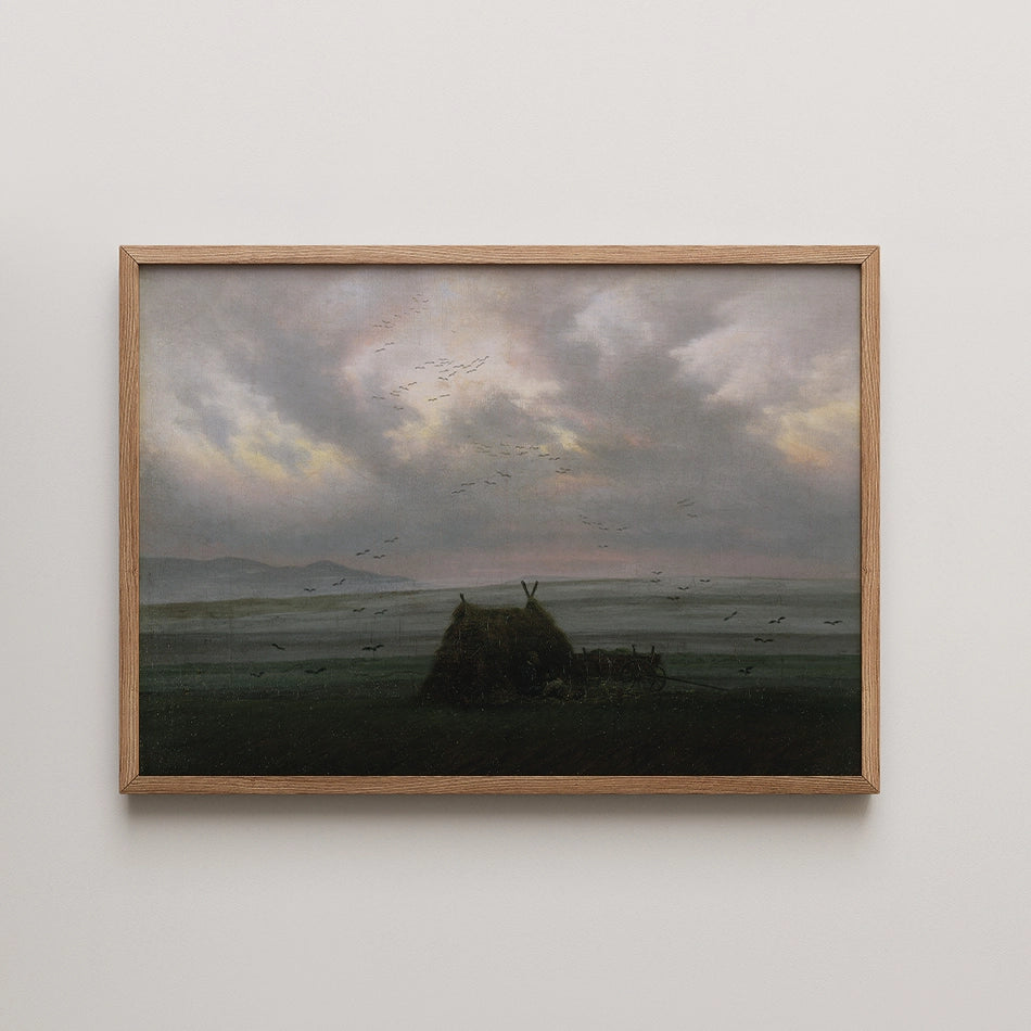 Landscape painting featuring a silhouette of a thatched hut against a moody sky filled with clouds and flying birds, framed in natural wood.
