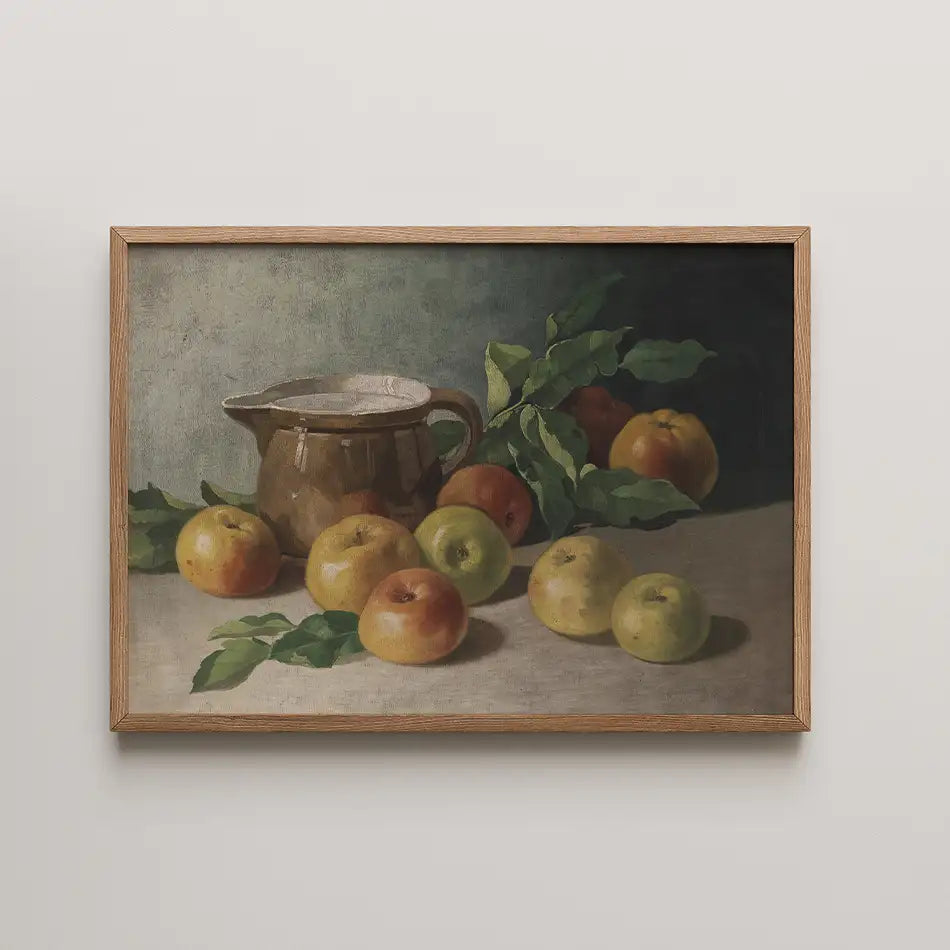 Still life painting of a brown jug surrounded by green and red apples on a light surface, framed in wood.