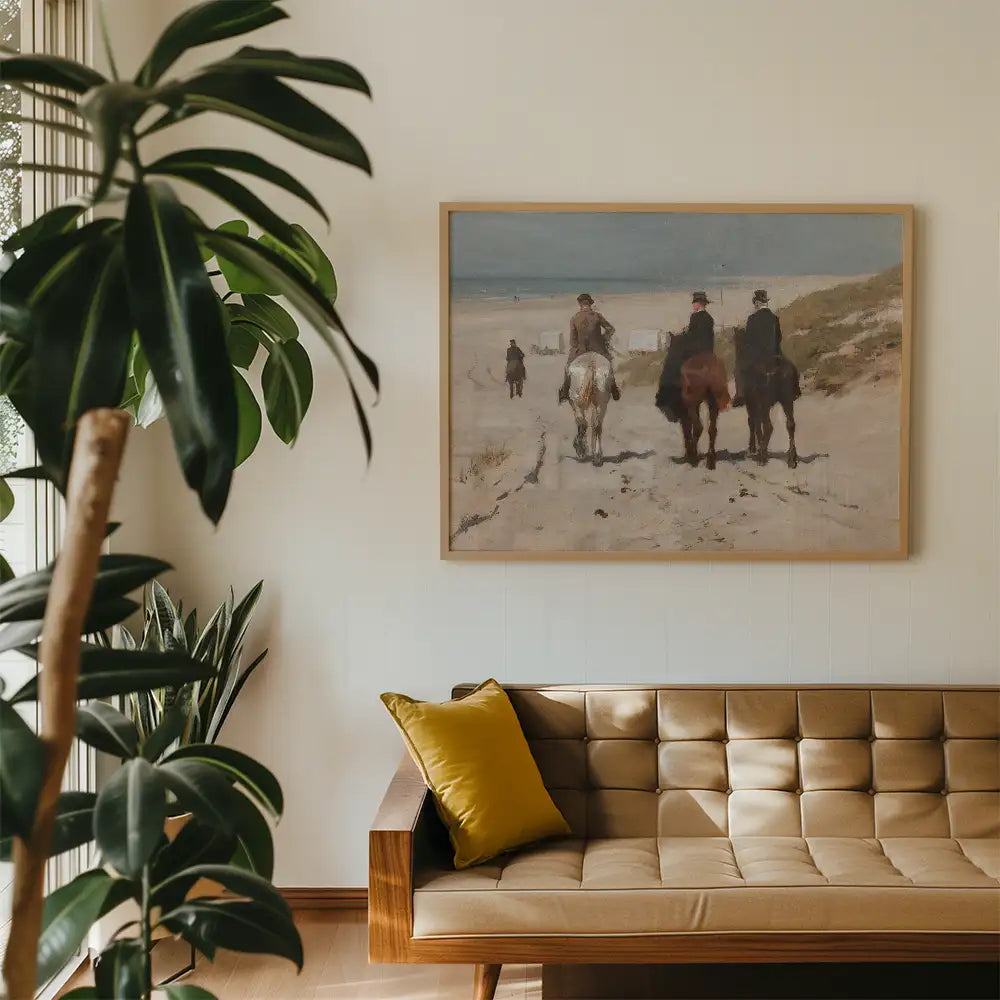Painting of three riders on horseback along a beach trail, framed and displayed above a modern couch with a decorative pillow, surrounded by indoor plants.