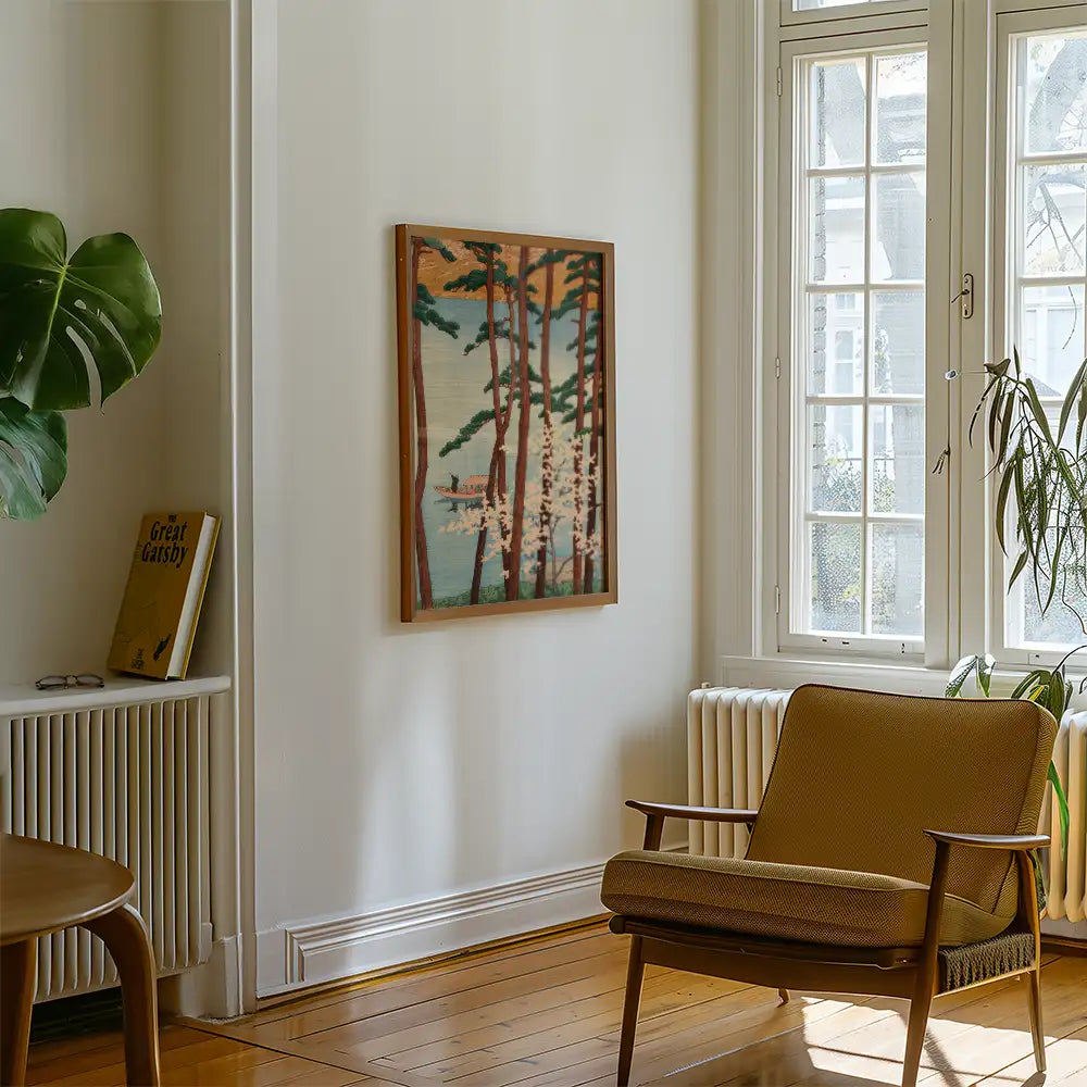 Painting of trees by a lake in a modern living room setting with a chair and a plant.
