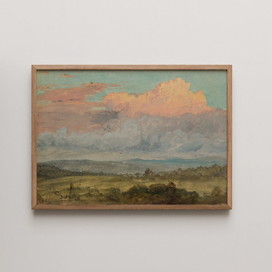 Framed painting of a serene landscape with colorful clouds and rolling hills in the foreground