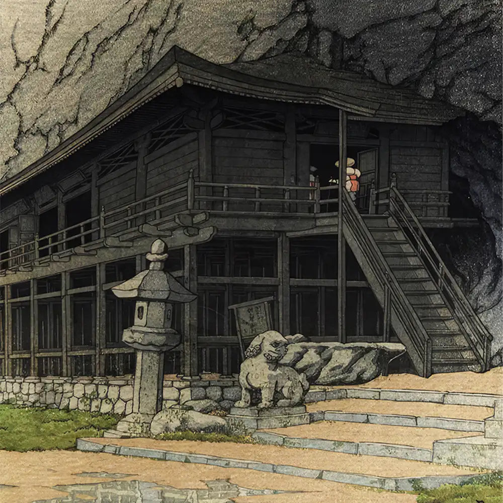 Traditional Japanese wooden building with a staircase, stone lantern, and guardian lion statue in a mountainous setting, featured in a detailed painting.