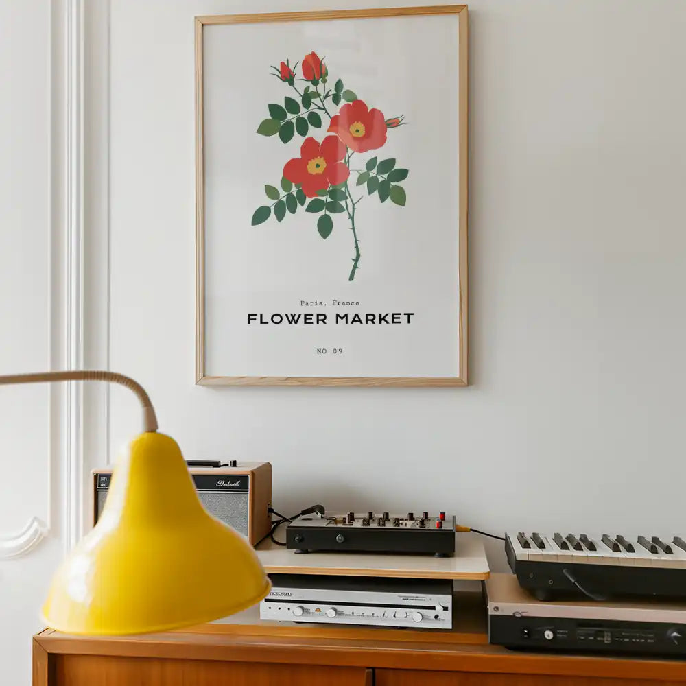 Modern floral poster featuring vibrant red flowers and lush green leaves, titled "Flower Market" and inspired by Paris, France, framed in a stylish wooden border.