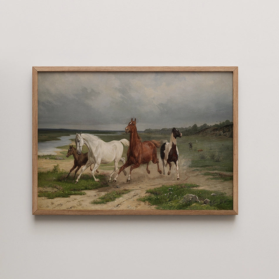 Painting of four horses running along a dirt path beside a river, with a cloudy sky and green landscape in the background, framed in light wood.