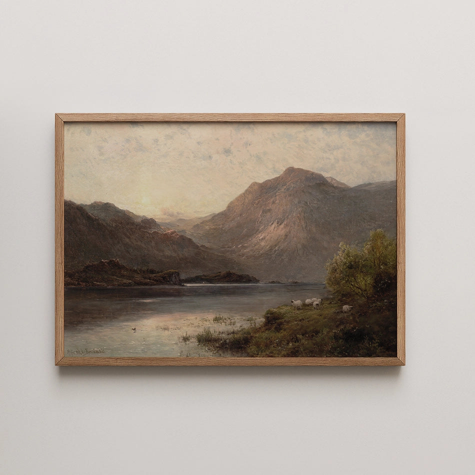 Framed painting of a serene landscape featuring mountains, a lake, and sheep grazing in a lush green setting during sunset.