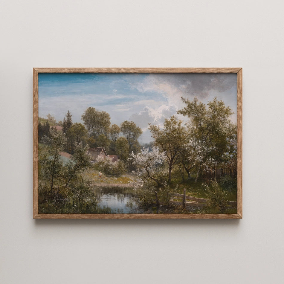 Painting of a serene landscape featuring a pond, blooming trees, and a small cottage, framed in light wood.