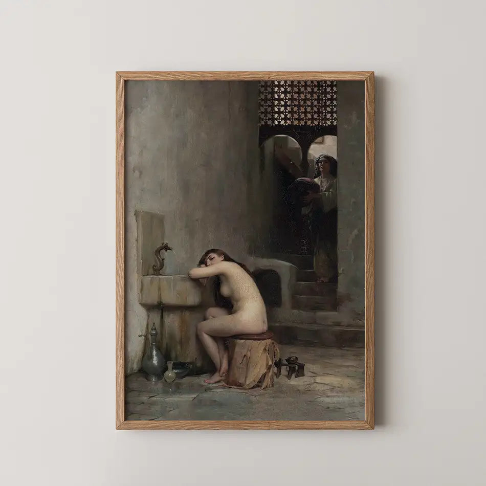 Nude woman seated by a fountain in an art piece, with a second figure holding a book in the background, framed in wood.